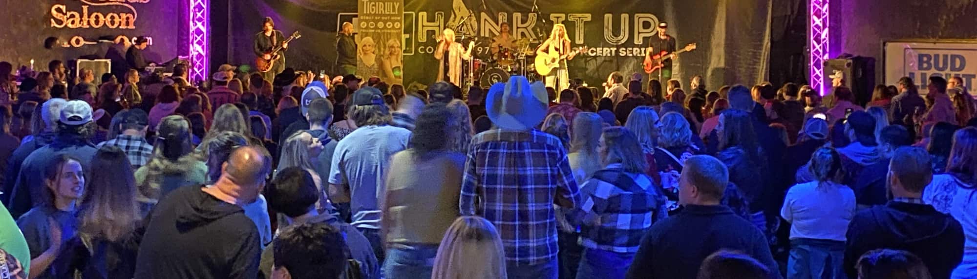 country concert with fans wearing cowboy hats Houston